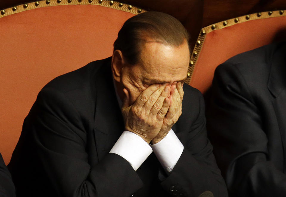 FILE - People of Freedom party leader Silvio Berlusconi rubs his eyes after delivering his speech at the Senate, in Rome, on, Oct. 2, 2013. Berlusconi, the boastful billionaire media mogul who was Italy's longest-serving premier despite scandals over his sex-fueled parties and allegations of corruption, died, according to Italian media. He was 86. (AP Photo/Gregorio Borgia, File)