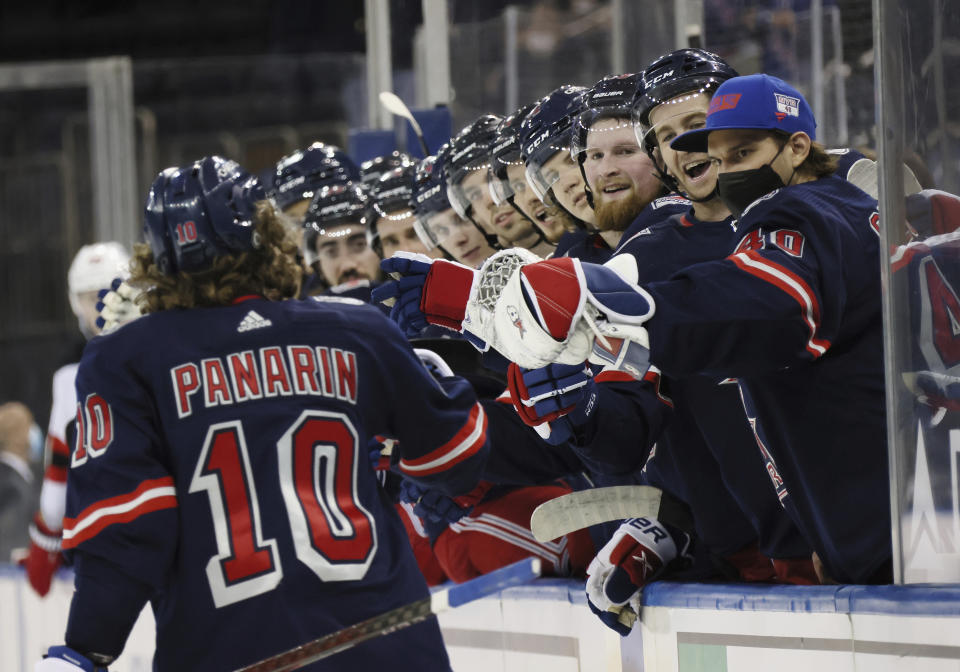 New York Rangers' Artemi Panarin (10) is congratulated for his second-period goal against the New Jersey Devils in an NHL hockey game Thursday, April 15, 2021, in New York. (Bruce Bennett/Pool Photo via AP)