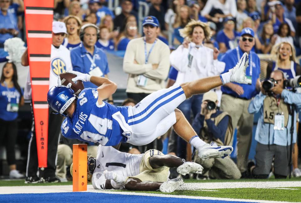 UK's Josh Kattus arches into the end zone for a touchdown early in Saturday's game vs. Akron.