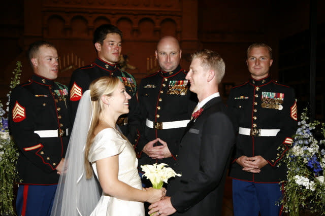 Claire and Josh Russo on their wedding day, with friends from the Marines. 