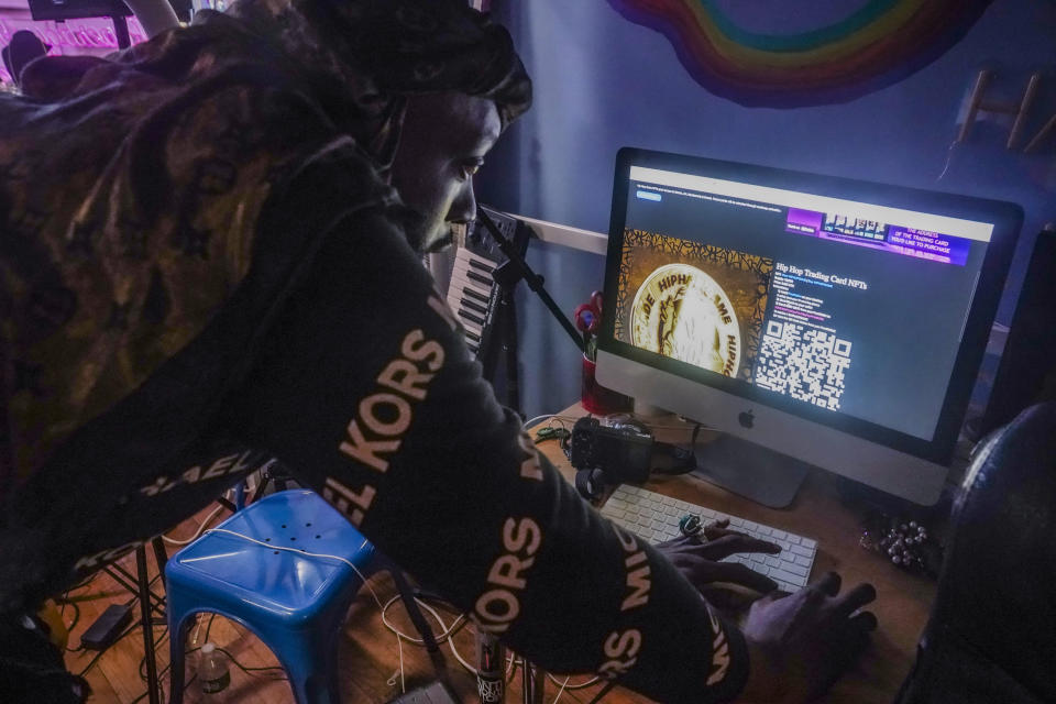 Crypto investor Tyrone Norris, also, known as Mental Stamina, loads a website to kick-off a popup livestream event for "Hiphop.Game," a metaverse platform he created to market NFTs and its related cryptocurrency "@Joincoin," Friday Jan. 27, 2023, at Love Gallery in Brooklyn, N.Y. (AP Photo/Bebeto Matthews)