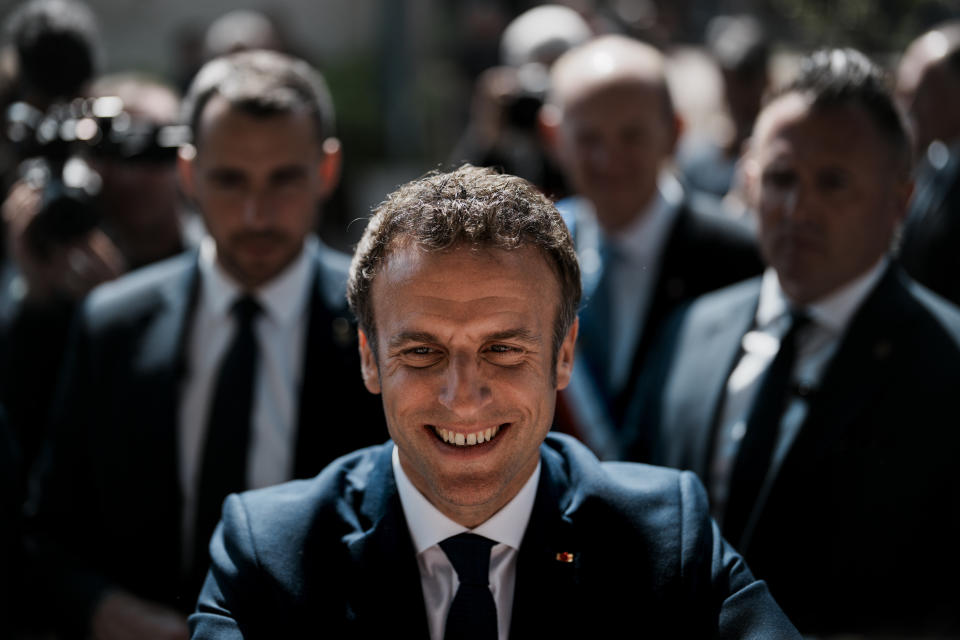 French President and centrist candidate Emmanuel Macron greets well-wishers after casting his vote in Le Touquet, northern France, Sunday, April 24, 2022. France began voting in a presidential runoff election Sunday with repercussions for Europe's future, with centrist incumbent Emmanuel Macron the front-runner but fighting a tough challenge from far-right contender Marine Le Pen. (AP Photo/Thibault Camus)