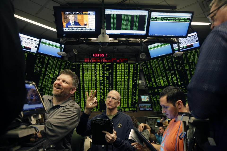 Traders work in a trading pit at the Chicago Board Options Exchange. Trading in Bitcoin futures began Sunday (12/10) on the CBOE. (AP Photo/Kiichiro Sato)