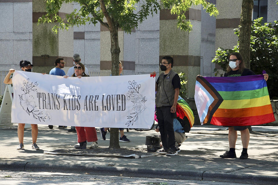 LGBTQ+ rights supporters rally in support of transgender youth outside the state Legislative Building in Raleigh, N.C., Wednesday, Aug. 16, 2023. North Carolina Republicans will attempt Wednesday to override the Democratic governor's veto of legislation banning gender-affirming health care for minors. (AP Photo/Hannah Schoenbaum)