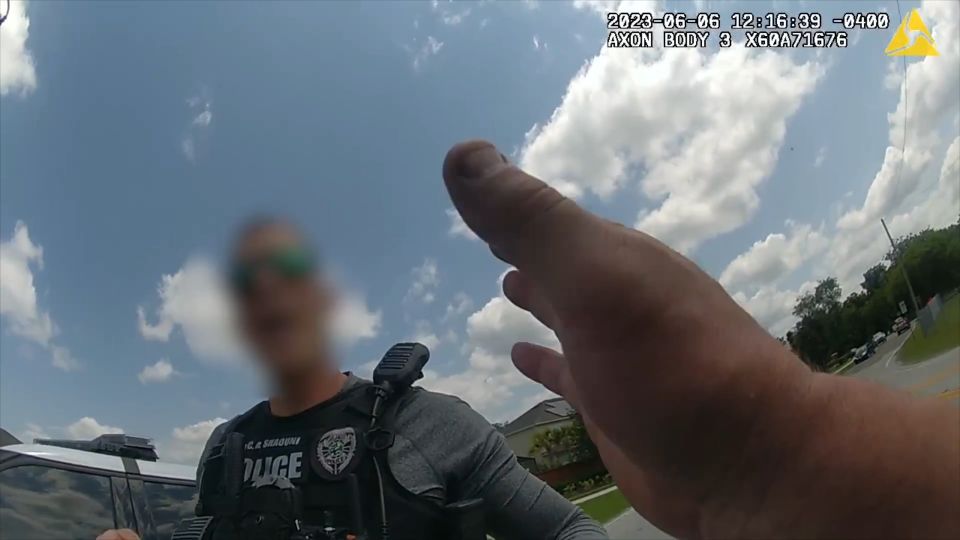 Heated body cam video shows an Orlando police officer drive off after being stopped for speeding on June 9, 2023. The officer, seen in the background here, was later arrested on charges including fleeing police and speeding.