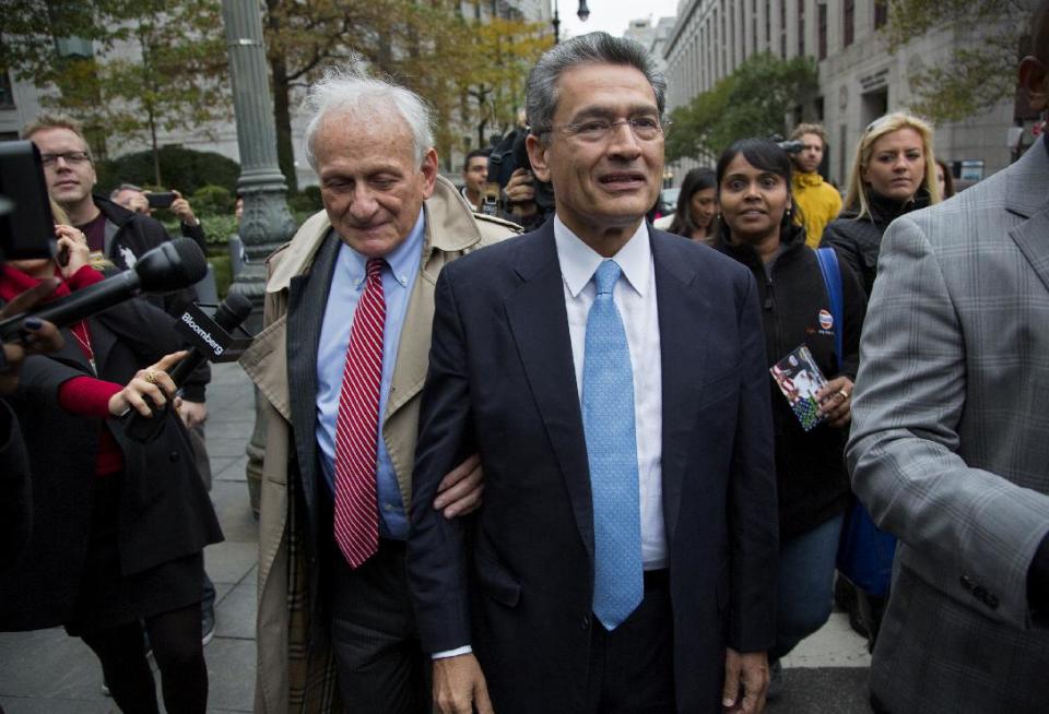 Rajat Gupta, center right, leaves federal court in New York, Wednesday, Oct. 24, 2012 after the former Goldman Sachs and Procter & Gamble Co. board member was sentenced Wednesday to 2 years in prison for feeding inside information about board dealings with a billionaire hedge fund owner who was his friend. At left is Gupta's attorney, Gary Naftalis. (AP Photo/Craig Ruttle)