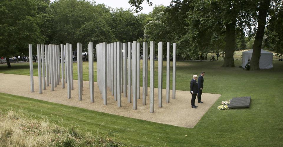 London Mayor Boris Johnson (L) and Britain's Prime Minister David Cameron pause after laying wreaths at the memorial to victims of the July 7, 2005 London bombings, in Hyde Park, central London, Britain July 7, 2015. Britain fell silent on Tuesday to commemorate the 10th anniversary of attacks targeting London public transport which killed 56 people, the first suicide bombings by Islamist militants in western Europe. (REUTERS/Steve Parsons/pool)