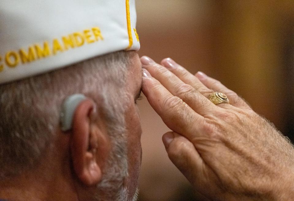 Mark Gullion, Indianapolis, salutes the colors, at the Indiana War Memorial, Thursday, May 26, 2022, a few days before the Indianapolis 500 and Memorial Day. The event drew local dignitaries for a service honoring Hoosier soldiers lost in the line of duty. 
