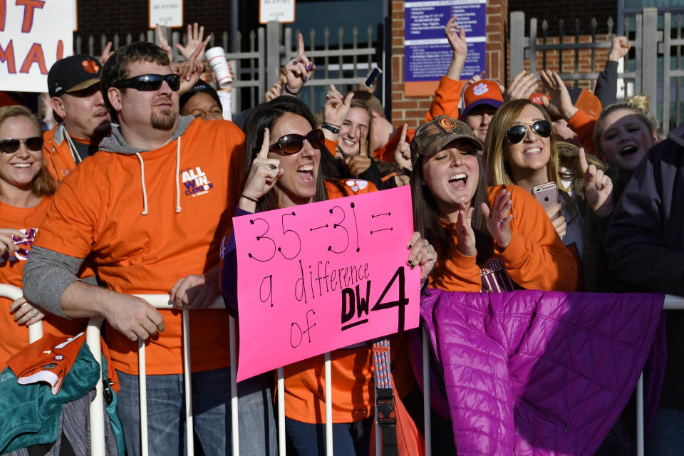 Clemson fans cheer as the Clemson Tigers return Tuesday, Jan. 10, 2017, in Clemson, S.C., the day after Clemson defeated Alabama 35-31 in the NCAA College Football Playoff championship game in Tampa, Fla. (AP Photo/Richard Shiro)