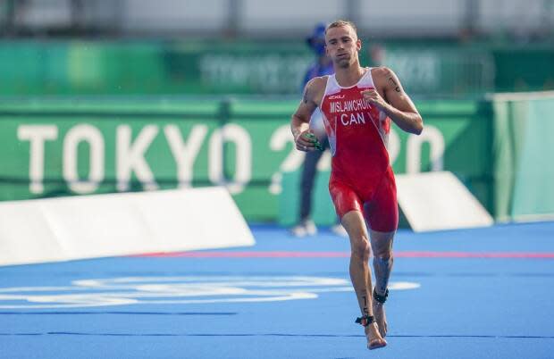 Canadian triathlete Tyler Mislawchuk has withdrawn from the mixed team relay event at the Tokyo Olympics on Friday due to an Achilles injury he sustained in last Sunday's individual race. (Leah Hennel/The Canadian Press - image credit)