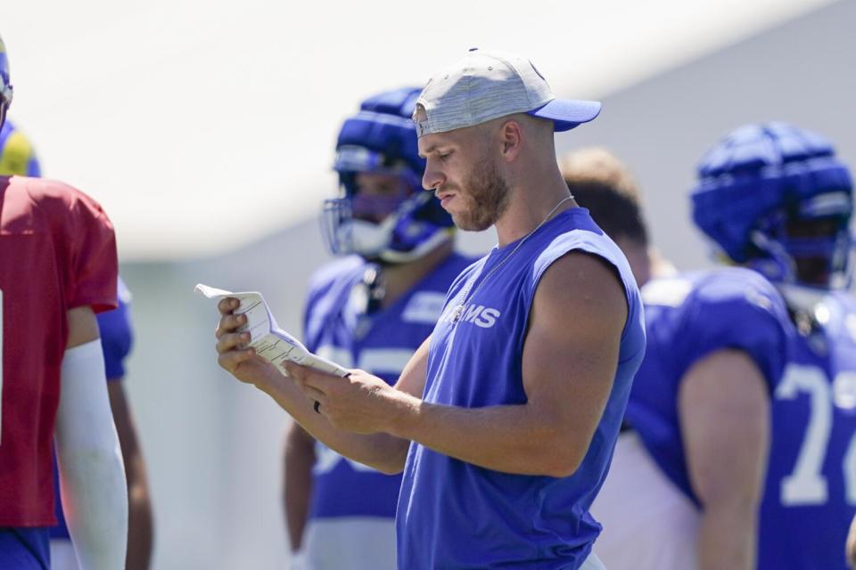 Rams wide receiver Cooper Kupp looks at notes from the sideline during a joint with the Raiders.