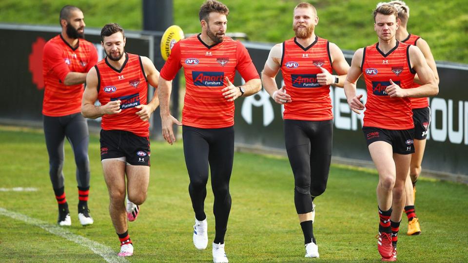 Conor McKenna (second from left) with teammates at Essendon training.