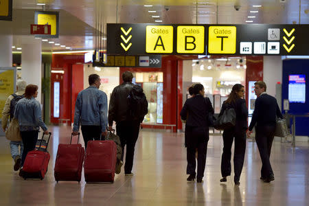 Members of staff and travellers walk in the departure hall after a ceremony at Brussels Airport as it reopens 40 days after deadly attacks in Zaventem, Belgium, May 1, 2016. REUTERS/Eric Vidal