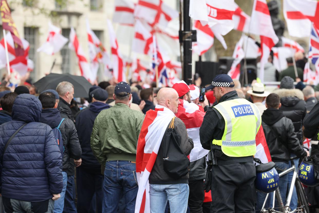 London, UK, 23rd April 2024. The Met Police deployed extra officers as 'far right groups' travelled from around the UK to mark St George's Day on Whitehall. The road was closed as a huge crowd with England flags gathered to listen to speeches, including one from Tommy Robinson. Credit : Monica Wells/Alamy Live News