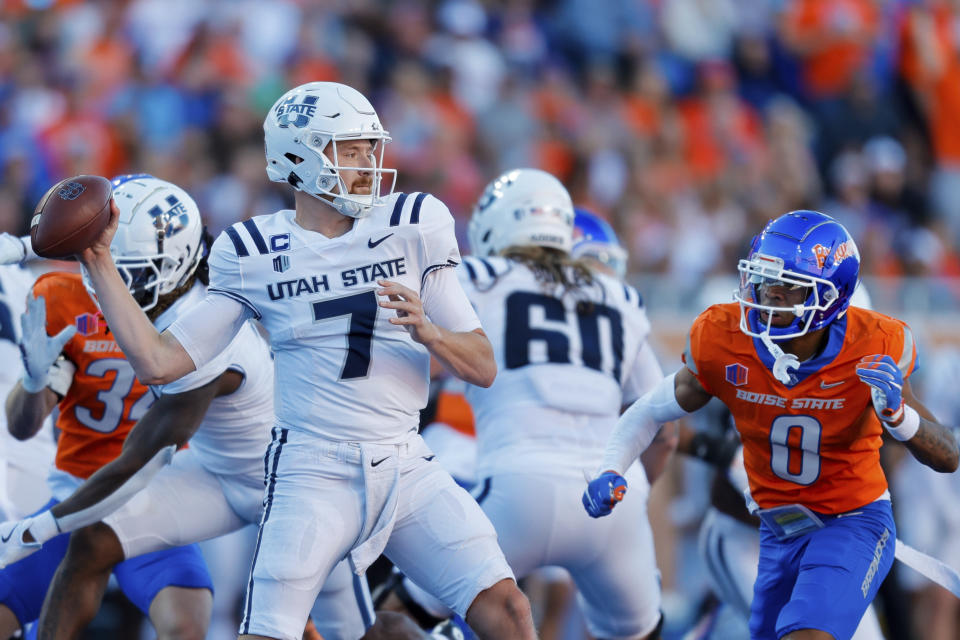 Utah State quarterback Spencer Petras (7) is pressured as he throws the ball by Boise State safety Ty Benefield (0) in the first half of an NCAA college football game, Saturday, Oct. 5, 2024, in Boise, Idaho. . (AP Photo/Steve Conner)