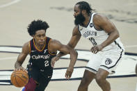Cleveland Cavaliers' Collin Sexton (2) drives past Brooklyn Nets' James Harden (13) during the first half of an NBA basketball game, Wednesday, Jan. 20, 2021, in Cleveland. (AP Photo/Tony Dejak)