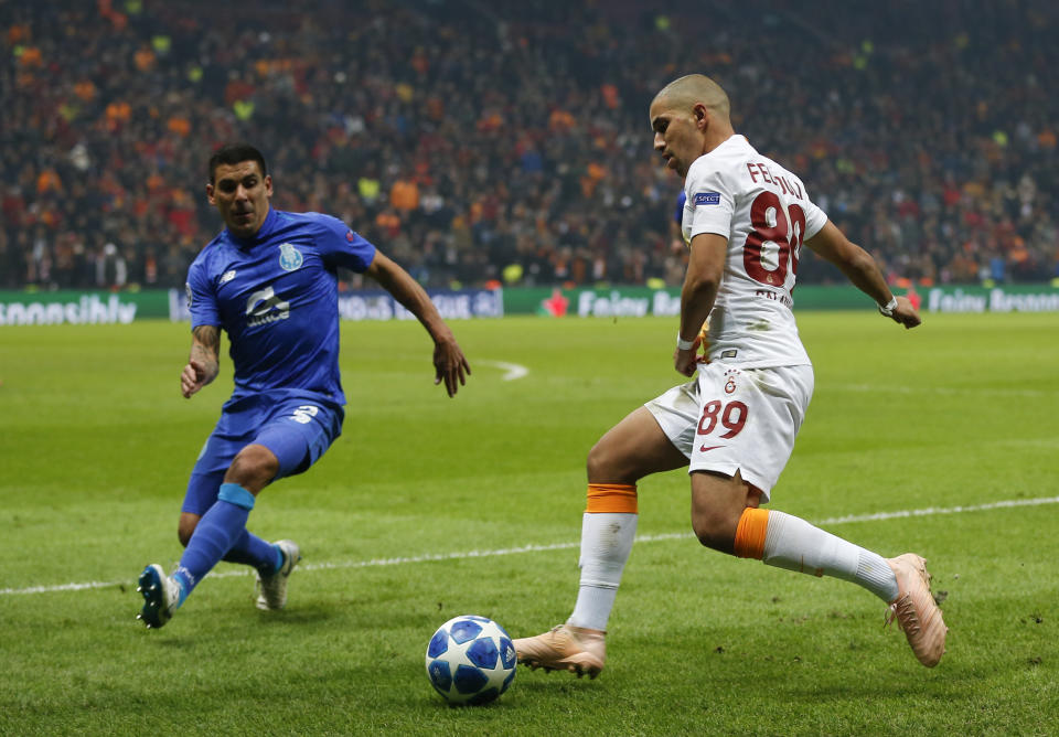 Galatasaray midfielder Sofiane Feghouli, right, fights for the ball with Porto defender Maxi Pereira during the Champions League Group D soccer match between Galatasaray and Porto in Istanbul, Tuesday, Dec. 11, 2018. (AP Photo/Lefteris Pitarakis)