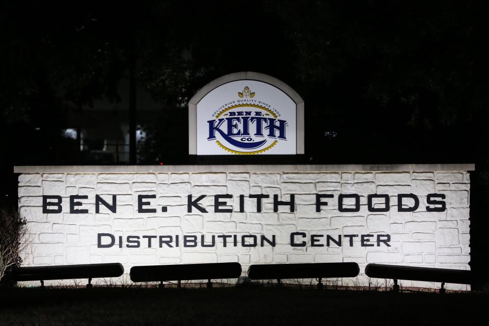 Lights illuminate a sign at Ben E. Keith distribution center as authorities investigate a deadly shooting at the distribution center Monday, Aug. 20, 2018, in Missouri City, Texas. Missouri City Police Chief Mike Berezin says the shooting happened during the overnight shift, when fewer workers are on duty. (Yi-Chin Lee/Houston Chronicle via AP)