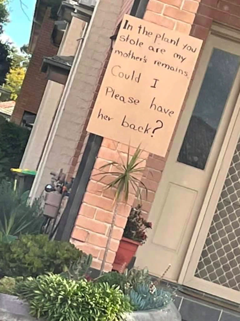 A sign hung at the front of a house pleads for the return of a pot plant that contains the remains of the owner's mother.