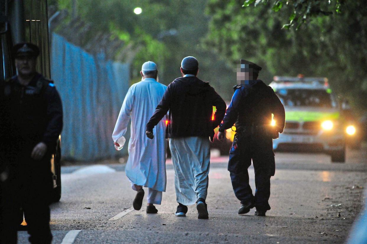 Raid: police at the school last month: Grant Falvey/LNP