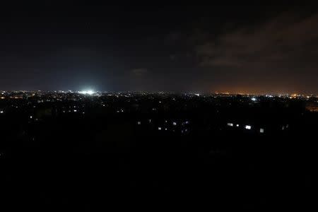 Buildings are seen at night during a power cut in Gaza City, July 18, 2017. REUTERS/Mohammed Salem