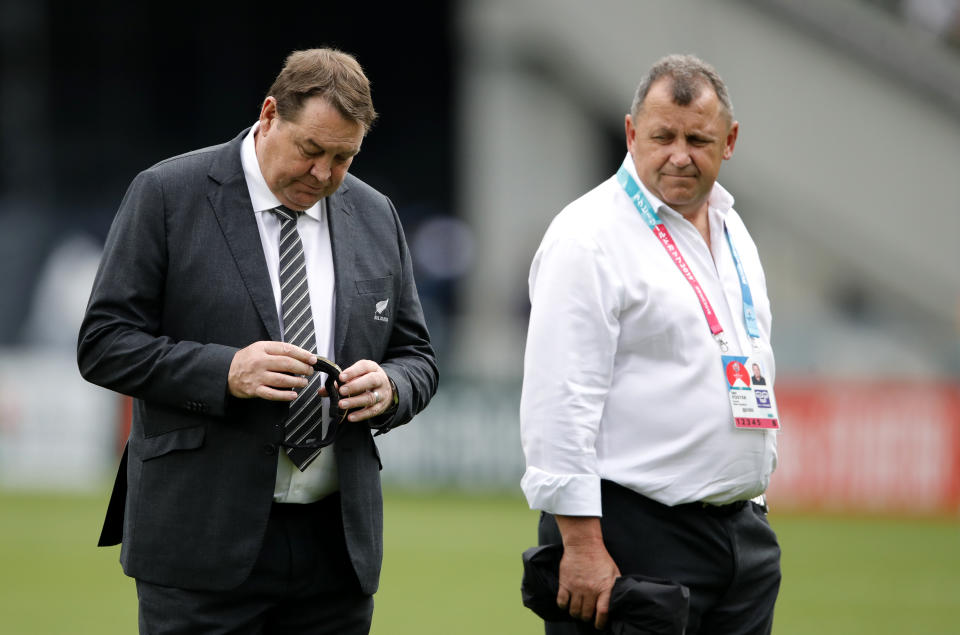 All Blacks coach Steve Hansen and his assistant Ian Foster walk on the pitch ahead of the Rugby World Cup Pool B game at Tokyo Stadium between New Zealand and Namibia in Tokyo, Japan, Sunday, Oct. 6, 2019. (AP Photo/Christophe Ena)