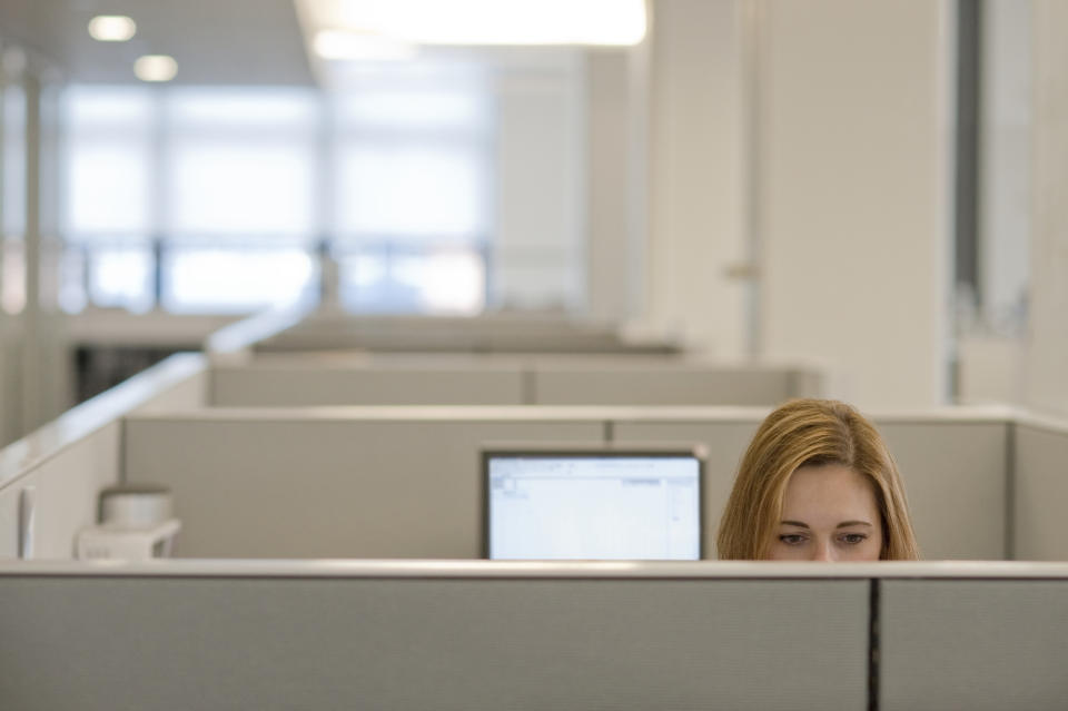 Businesswoman working in a cubicle