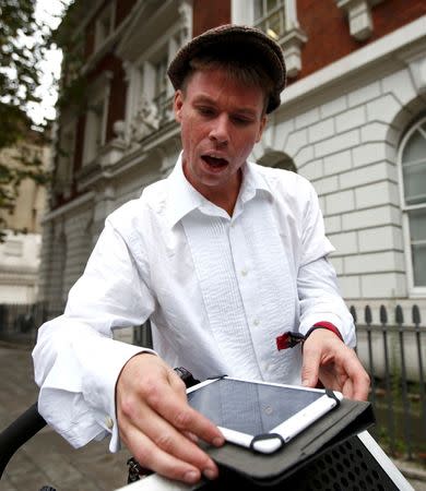 Lauri Love plays music from his tablet before dancing as he arrives for his extradition hearing at Westminster Magistrates' Court in London, Britain September 16, 2016. REUTERS/Peter Nicholls