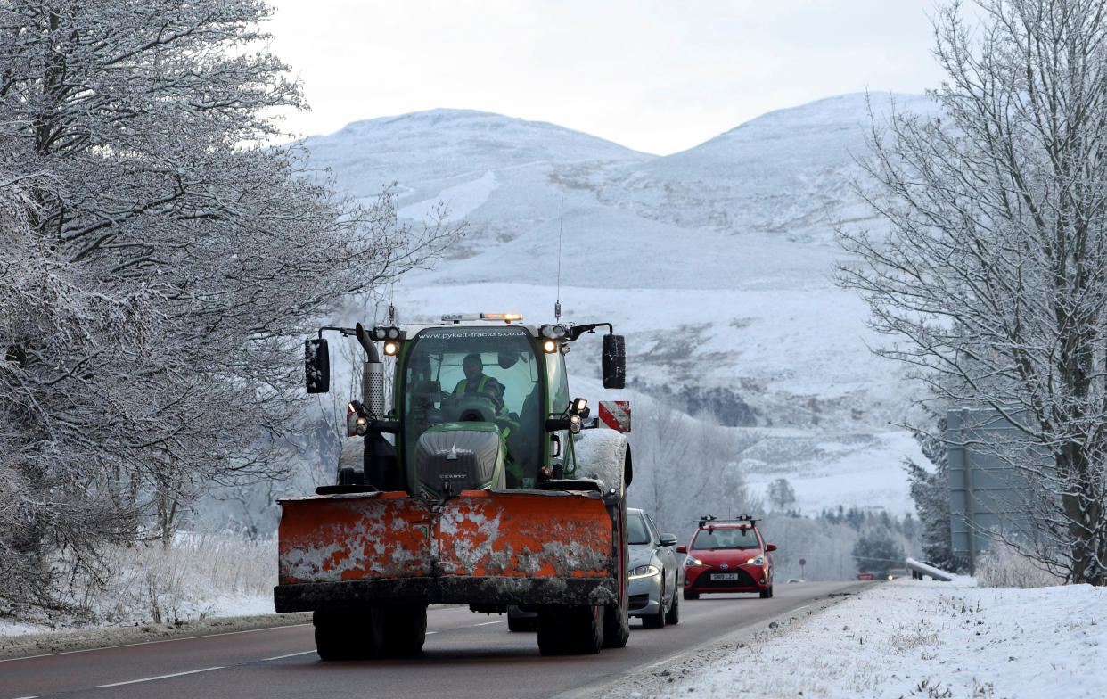 A tractor fitted with a snowplough drives on the the A9 near Pitlochry, Scotland, Britain December 17, 2022. REUTERS/Russell Cheyne