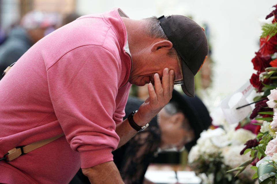 Rand Salwasser wipes tears from his face as he writes a message for U.S. Sen. Dianne Feinstein at City Hall Wednesday, Oct. 4, 2023, in San Francisco. Feinstein, who died Sept. 29, served as San Francisco's mayor. (AP Photo/Godofredo A. Vásquez)