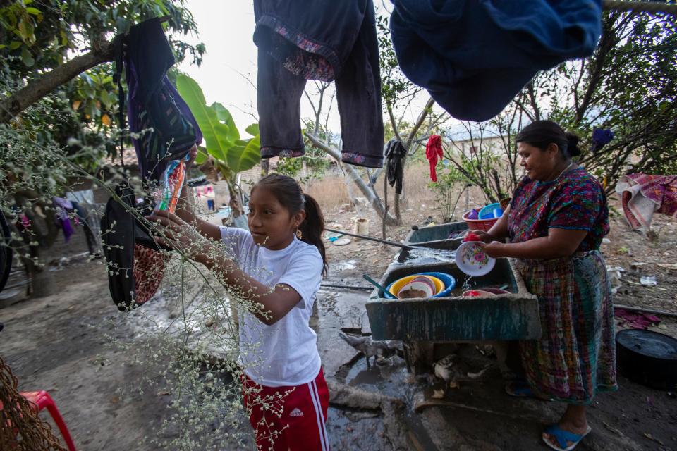 Melissa Sical and her mother, Maria Elvira Ramos, use well water to wash dishes in Baja Verapaz, Guatemala, in early March. Melissa and her father traveled to the U.S. border during the summer of 2019, where they were subjected to the Migrant Protection Protocols and required to wait in Juárez two months for a U.S. court hearing.