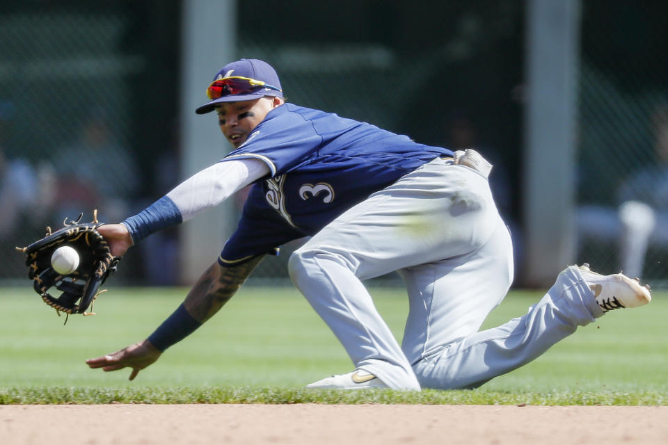 Milwaukee Brewers shortstop Orlando Arcia fields a ground ball hit by Cincinnati Reds' Aristides Aquino before throwing to first for the out in the seventh inning of a baseball game, Thursday, Sept. 26, 2019, in Cincinnati. (AP Photo/John Minchillo)