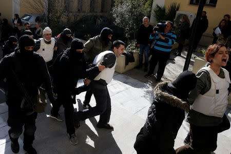 Eight men and a woman holding Turkish citizenship, who were arrested on suspected links to a leftist militant group outlawed in Turkey following an operation by Greek security services, are escorted by anti-terrorism police officers to the prosecutor's office in Athens, Greece, November 29, 2017. REUTERS/Alkis Konstantinidis