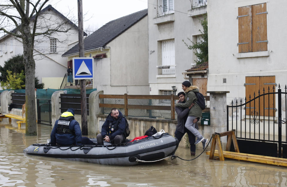 <p>Rescue workers evacuate residents in a flooded street of Villeneuve-Saint-Georges, outside Paris, where the Yerres river floods on Thursday, Jan.25, 2018. (Photo: Thibault Camus/AP) </p>