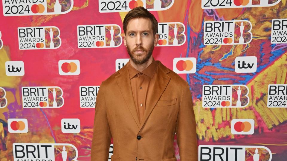 Calvin Harris in a brown suit