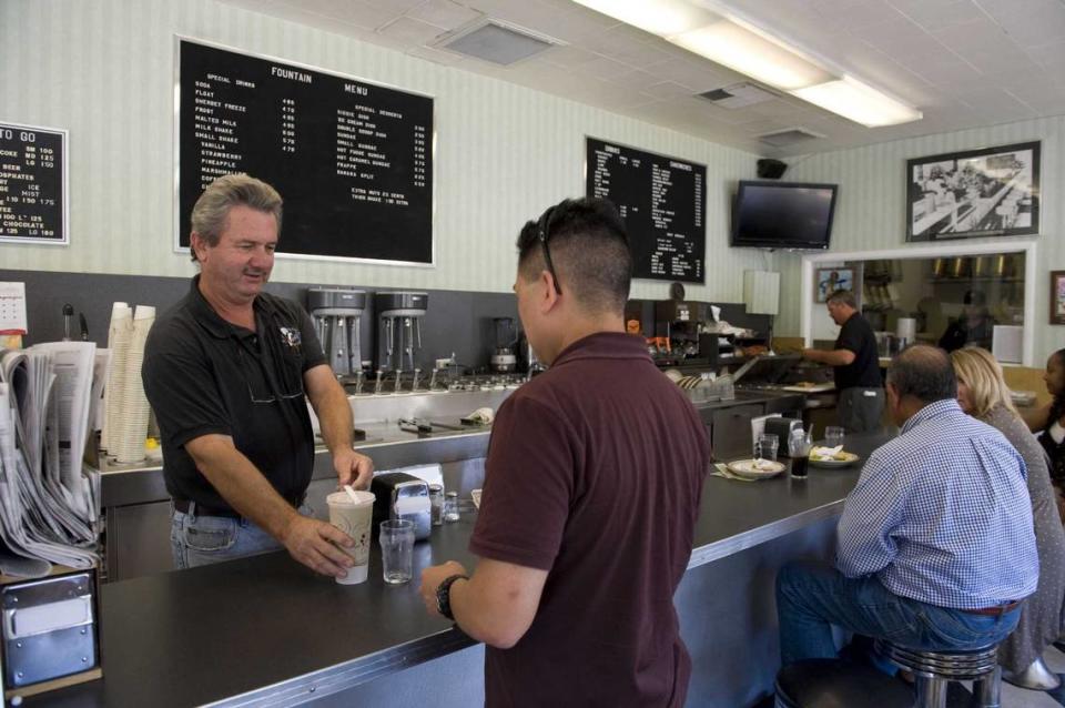 Craig Rutledge serves a customer on Tuesday, September 14, 2010, at Vic’s Ice Cream shop in Land Park. Rutledge, who operated the ice cream parlor for 40 years, died Monday at the age of 73. Randy Pench/Sacramento Bee file