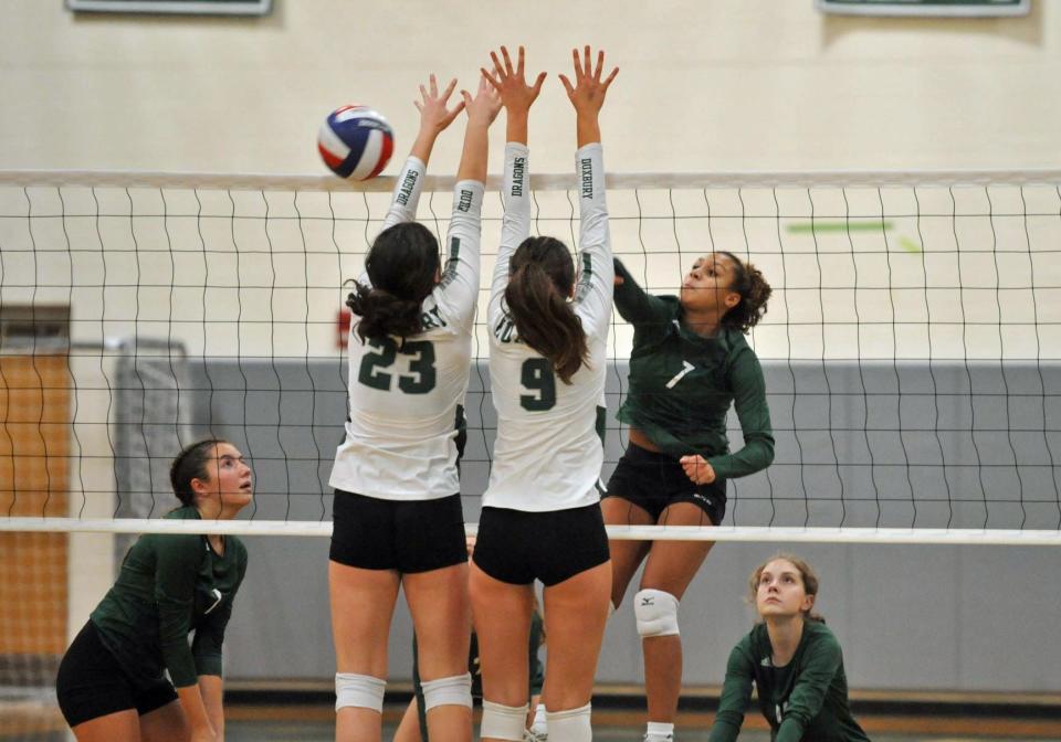 Dartmouth's Haley Jenkins, right, gets her shot past Duxbury's Aliana Cawley, left, and Danielle Beckerman, center, during girls volleyball action at Duxbury High School, Monday, Oct. 24, 2022.