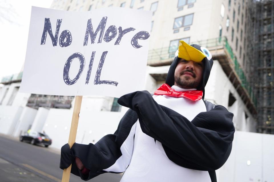 A demonstrator dressed as penguin outside Shell’s HQ in Lambeth, south east London as the firm announced record profits (PA)