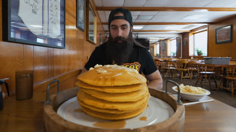 man with stack of pancakes