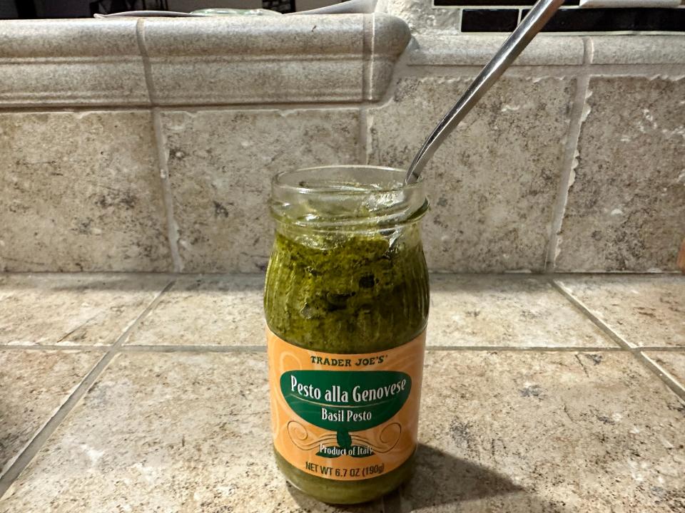 Trader Joe's pesto alla genovese with a spoon sticking out of jar