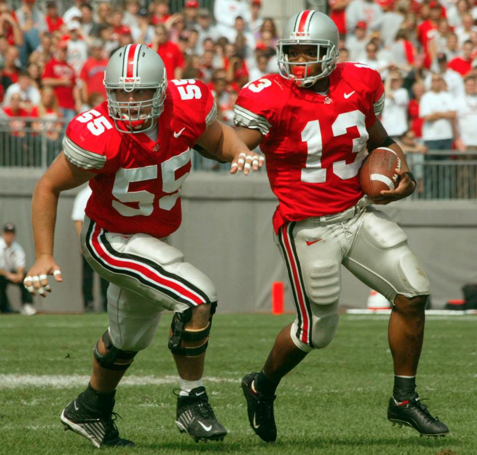 Ohio State's Maurice Clarett uses teammate Nick Mangold to clear the way for yardage against Indiana in 2002.