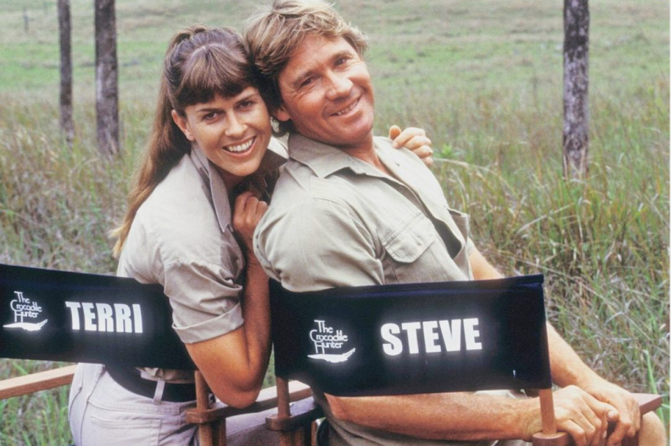 Terri and Steve Irwin seated in named director chairs on location.