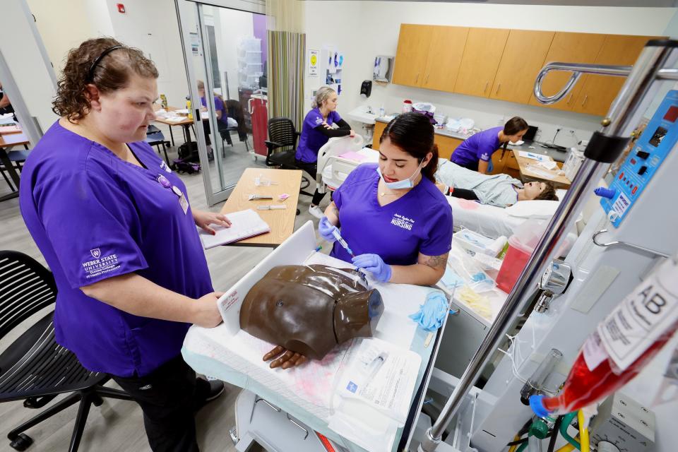 Nursing students Kalley Jaques and Aisha Holts work on a central line change as students work in the simulation lab in the Marriott Health Building at Weber State University in Ogden on Tuesday, Sept. 5, 2023. | Scott G Winterton, Deseret News