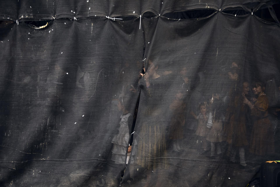 Ultra-Orthodox Jewish women are seen behind a curtain during the "Pidyon Haben" ceremony for Yossef Tabersky, a 30-day-old great grandchild of the chief rabbi of the Lelov Hassidic dynasty, in Beit Shemesh, Israel, Thursday, Sept. 16, 2021. The Pidyon Haben, or redemption of the firstborn son, is a Jewish ceremony hearkening back to the biblical exodus from Egypt. (AP Photo/Oded Balilty)