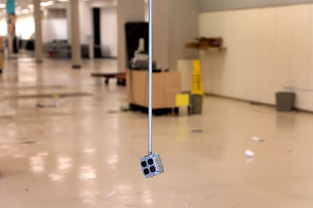 An electrical outlet hangs from the ceiling inside a Sears department store one day after it closed as part of multiple store closures by Sears Holdings Corp in the United States in Nanuet, New York, U.S., January 7, 2019. REUTERS/Mike Segar