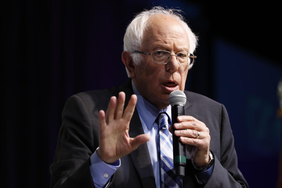 Democratic presidential candidate Sen. Bernie Sanders, I-Vt., speaks at the J Street National Conference, with the hosts of "Pod Save the World," Tommy Vietor, left, and Ben Rhodes, Monday, Oct. 28, 2019, in Washington. (AP Photo/Jacquelyn Martin)