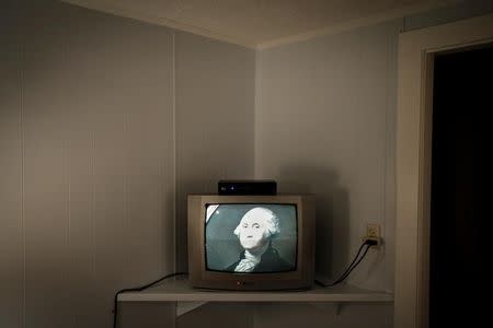 An image of George Washington, the first president of the United States, is seen on a television set inside a hotel room after voting began in the New Hampshire U.S. presidential primary election at midnight in Dixville Notch, New Hampshire, February 8, 2016. REUTERS/Mike Segar