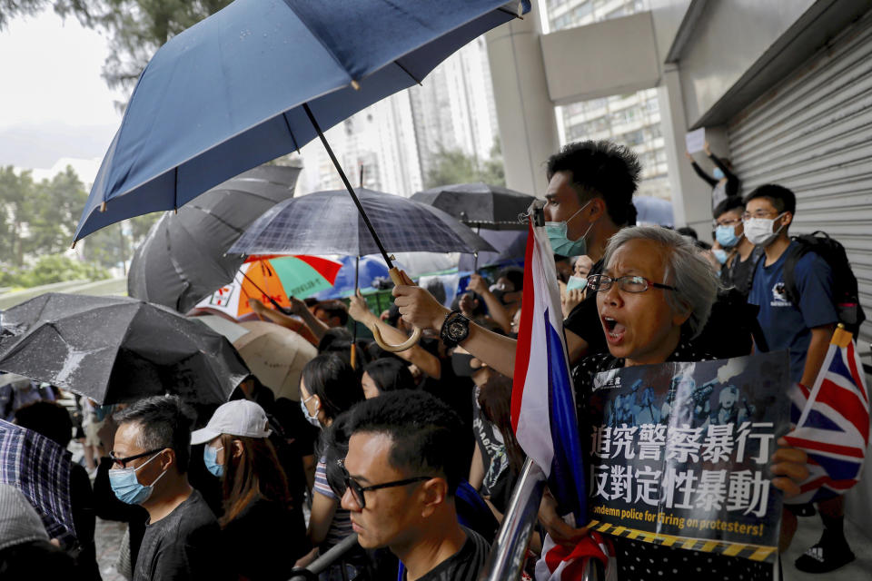 Protesters chant slogans as they gather outside the Eastern Court in Hong Kong, Wednesday, July 31, 2019. Supporters rallied outside a court in Hong Kong on Wednesday ahead of a court appearance by more than 40 fellow protesters who have been charged with rioting. (AP Photo/Vincent Yu)