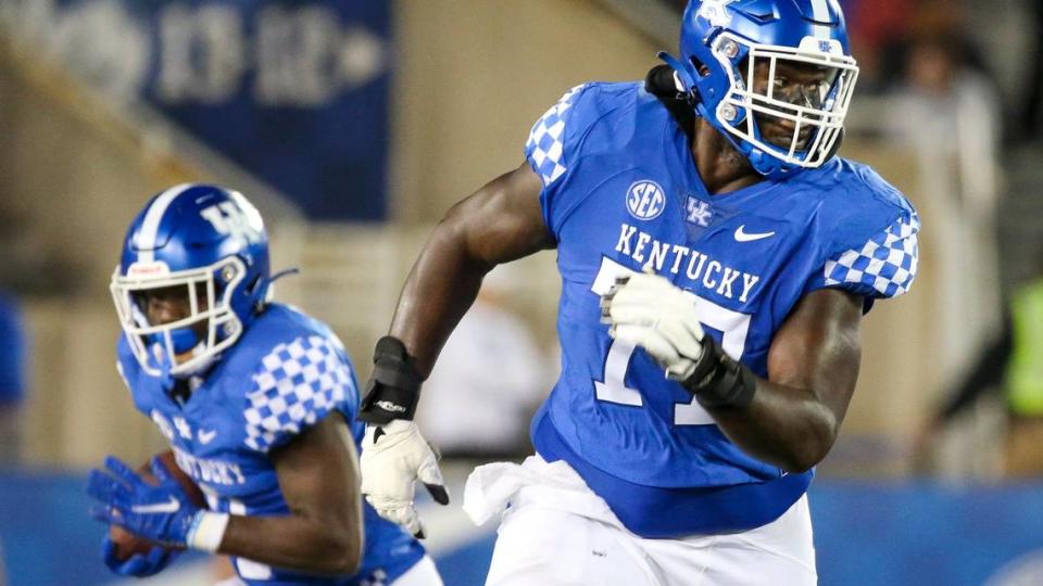 Kentucky offensive lineman Jeremy Flax, right, blocks downfield for running back Kavosiey Smoke (0) during the team’s game against Northern Illinois at Kroger Field on Sept. 24, 2022.