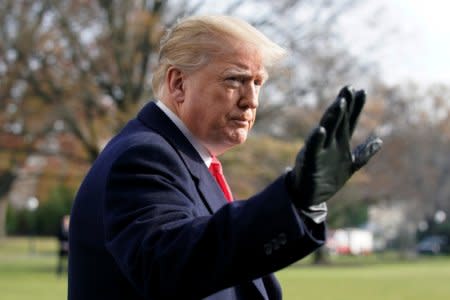 U.S. President Donald Trump waves to the media on the South Lawn of the White House in Washington before his departure for the annual Army-Navy college football game in Philadelphia, U.S., December 8, 2018. REUTERS/Yuri Gripas